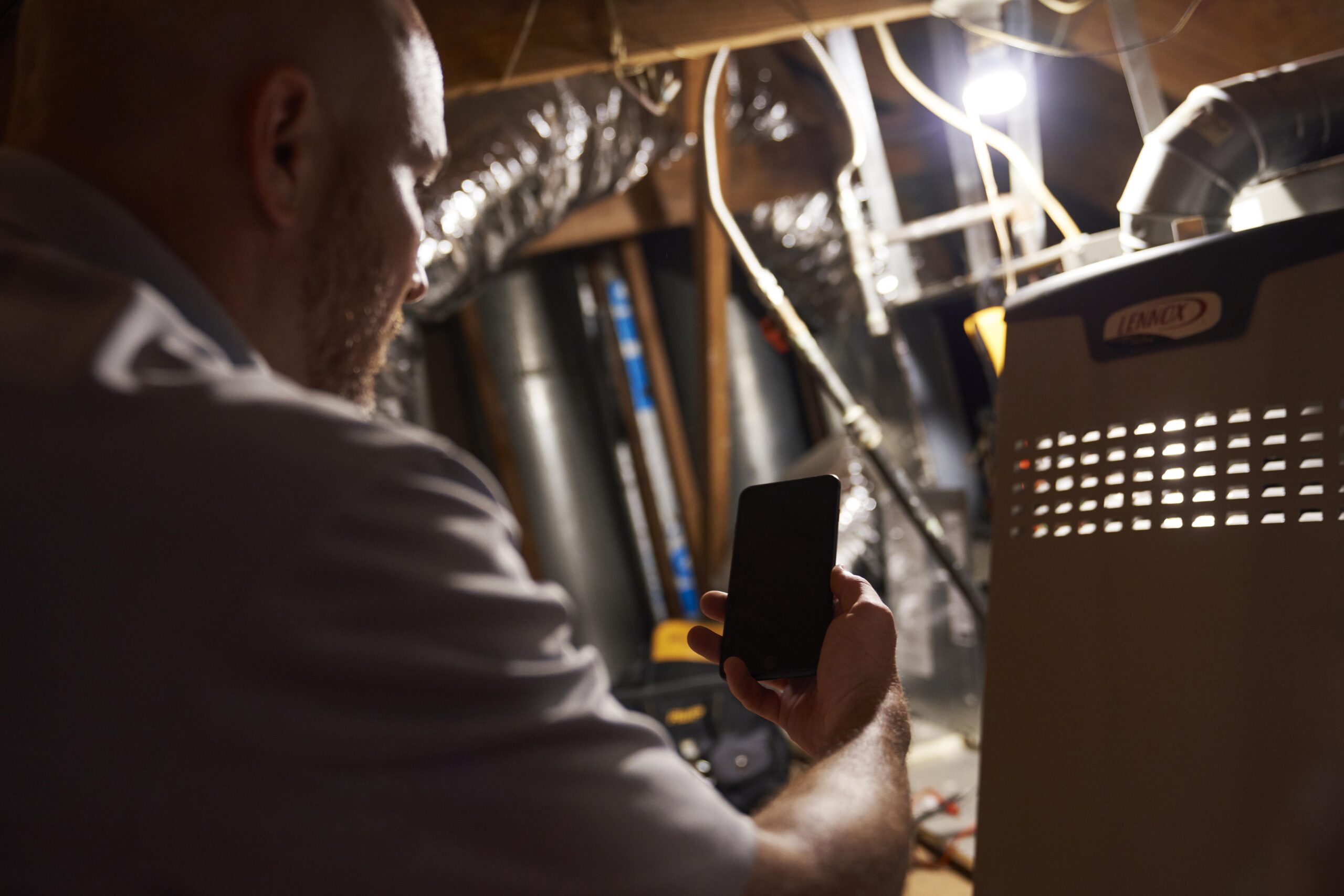 Experienced technician performing final safety checks on a new furnace in a Preston Hollow, TX remodeled home