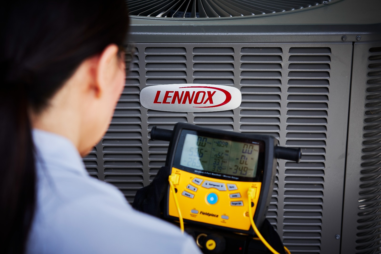 HVAC specialist inspecting AC unit in University Park, TX high-rise apartment for efficient performance
