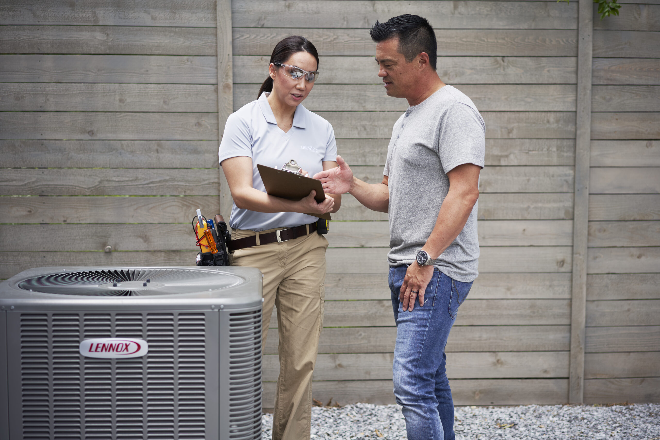 Skilled HVAC technician using diagnostic tools to optimize AC system performance in Highland Park, TX home