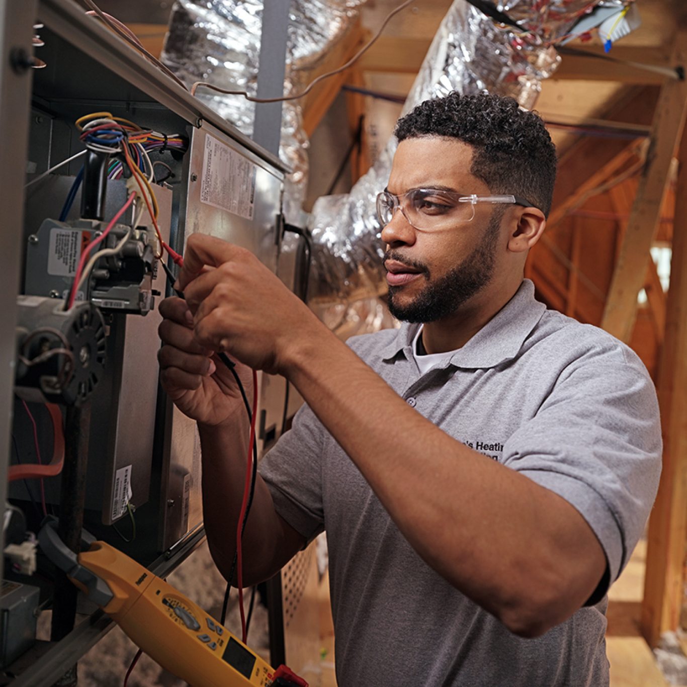 Experienced HVAC technician using precision tools on a sophisticated AC system in Highland Park, TX