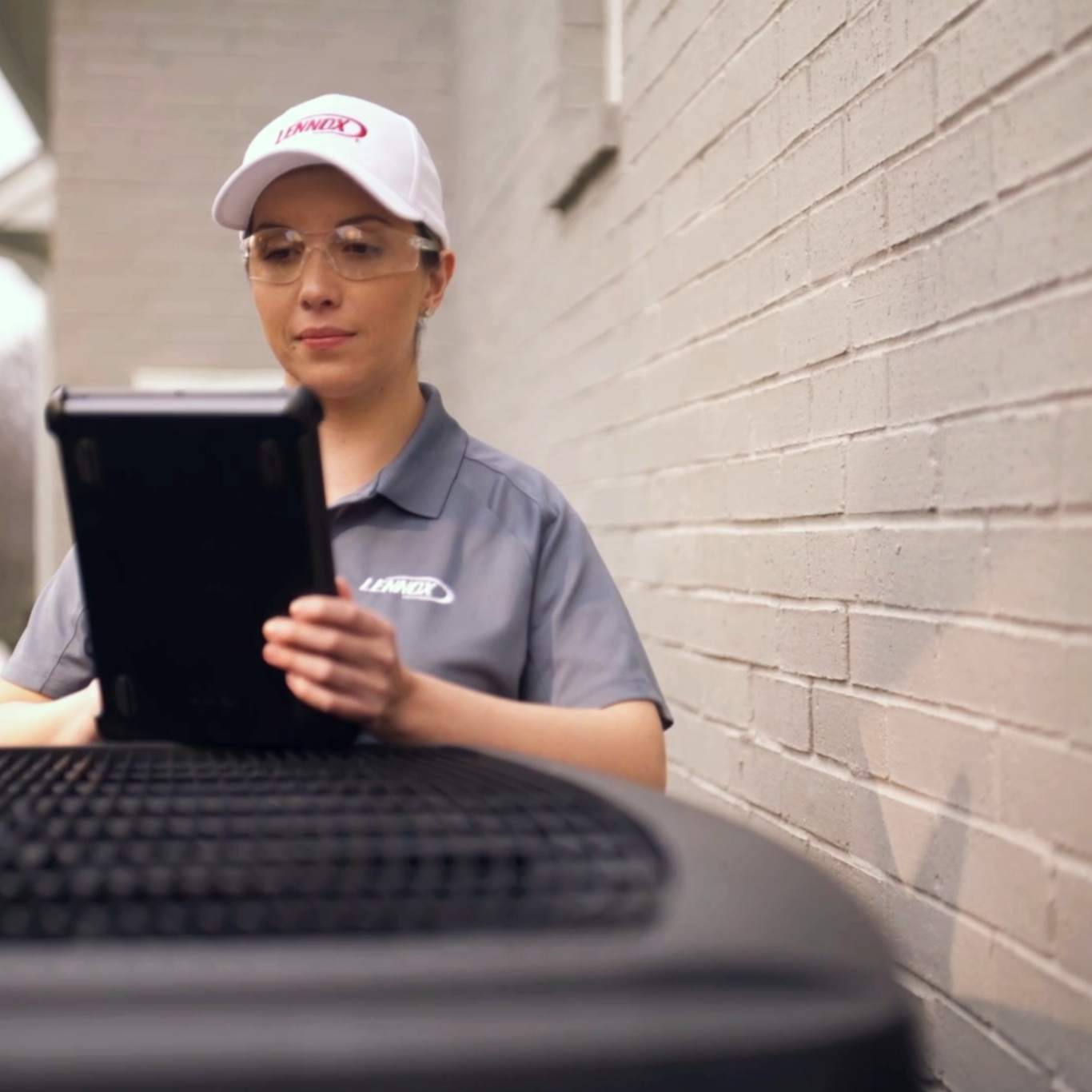Skilled HVAC technician using diagnostic tools to optimize AC system performance in Highland Park, TX home