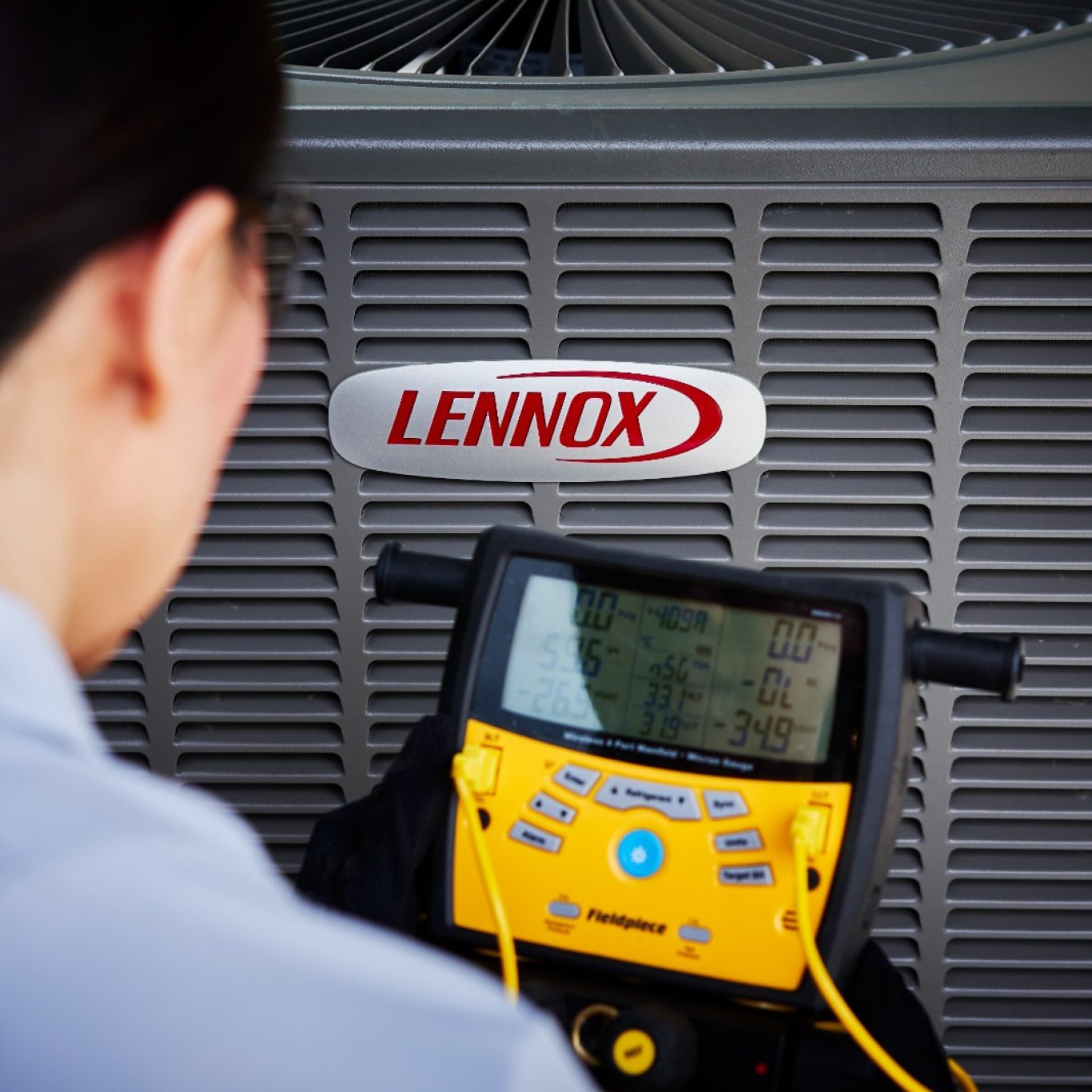 HVAC specialist inspecting AC unit in University Park, TX high-rise apartment for efficient performance